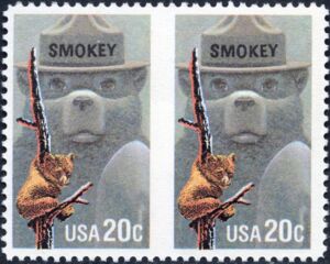 Smokey Bear & American Black Bear Cub clinging to burnt Tree