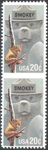 Smokey Bear & American Black Bear Cub clinging to burnt Tree